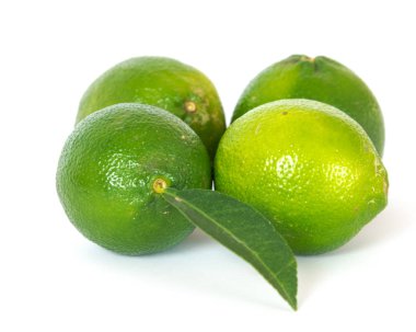 Four limes and leaf isolated on white