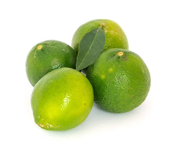 Four limes and leaf isolated on white — Stock Photo, Image