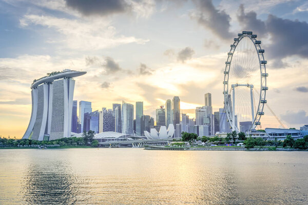 Singapore flyer and modern downtown skylines at sunset