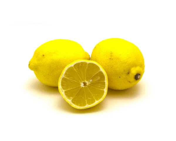 Studio shot pile of organic raw lemons with slice cuts isolated on white — Stok fotoğraf