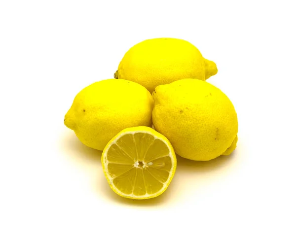 Studio shot pile of organic raw lemons with slice cuts isolated on white — Stock Photo, Image