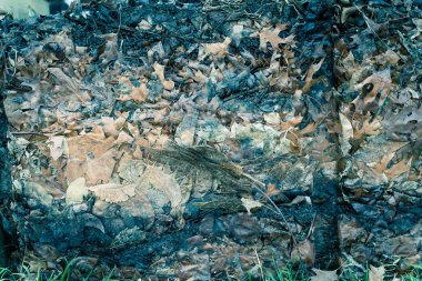 Close-up background of aged dried leaf mulch compost in a leaf pile
