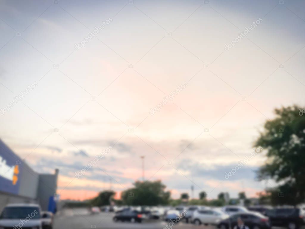 Blurry background outdoor parking garage with beautiful sunset cloud near Dallas