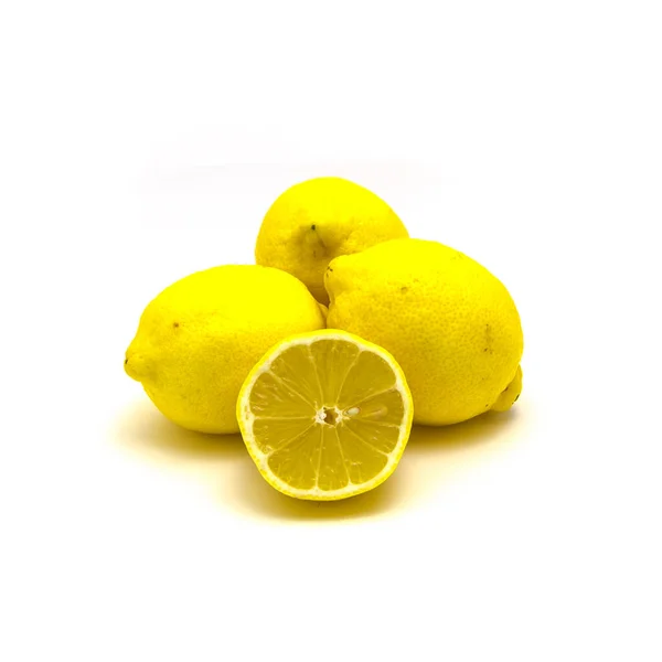 Studio shot pile of organic raw lemons with slice cuts isolated on white — Stok fotoğraf