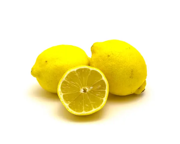 Studio shot pile of organic raw lemons with slice cuts isolated on white — 스톡 사진