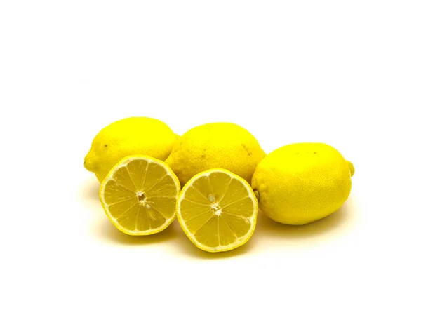 Studio shot pile of organic raw lemons with slice cuts isolated on white — Stok fotoğraf