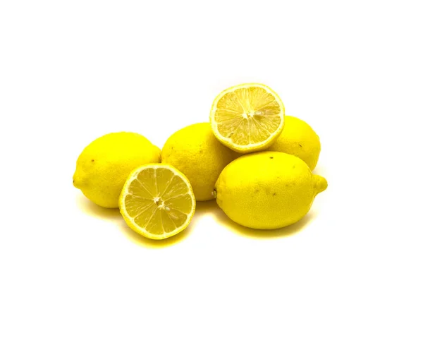 Studio shot pile of organic raw lemons with slice cuts isolated on white — 스톡 사진