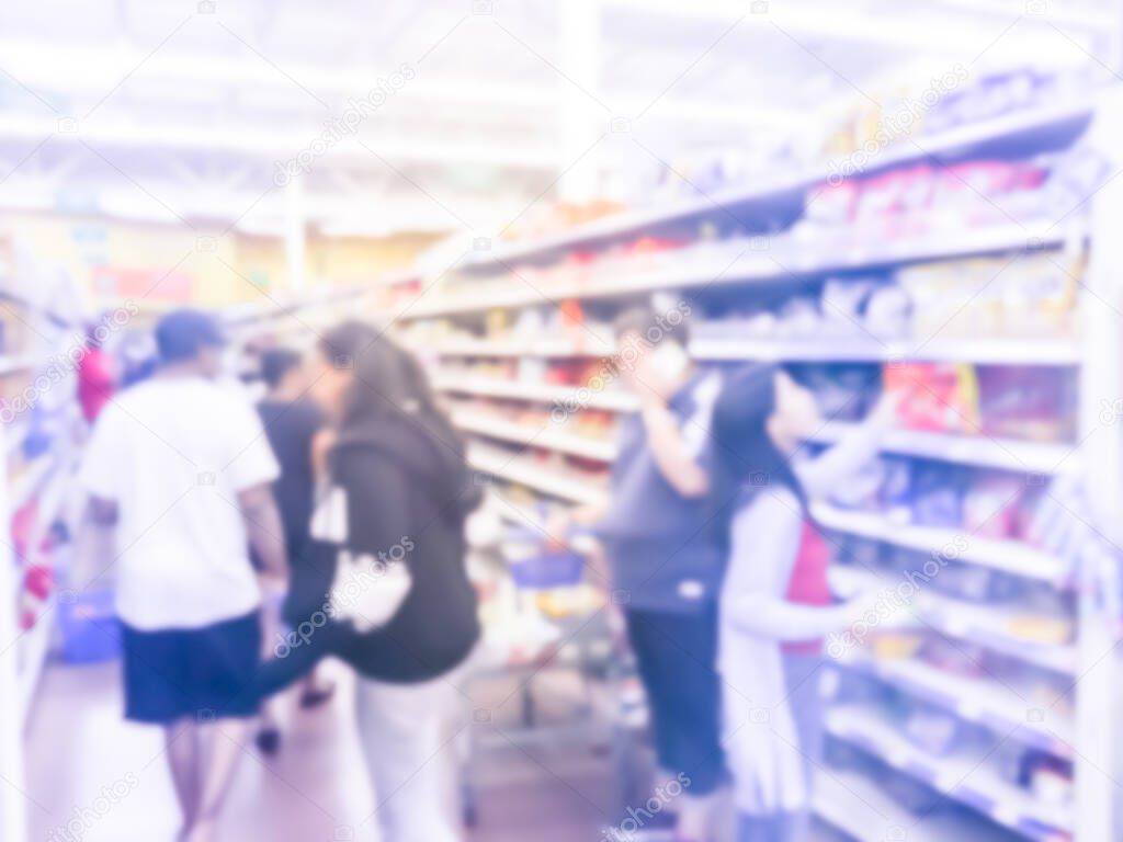 Blurry background diverse customers stock up candy at grocery stores in America