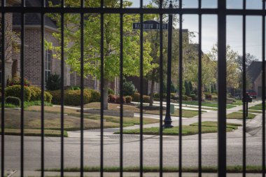 Shallow DOF on the metal fence of gated residential area in suburbs Dallas, Texas clipart