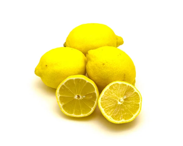 Студійний знімок купа органічних сирих лимонів зі скибочками ізольовані на білому — стокове фото
