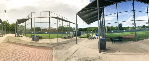 Panoramic view empty baseball field with metal chain link fence in Dallas, Texas, USA