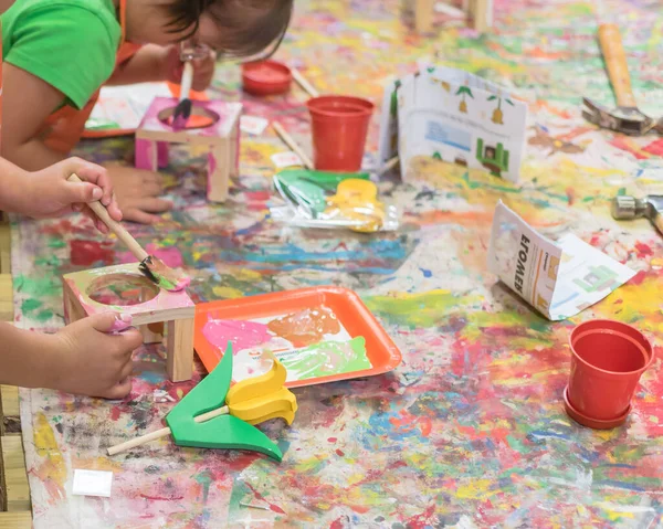 Kid hands painting craft at building workshop in local hardware store in Texas, USA