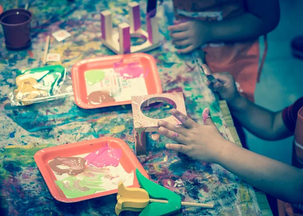 Kid hands painting craft at building workshop in local hardware store in Texas, USA