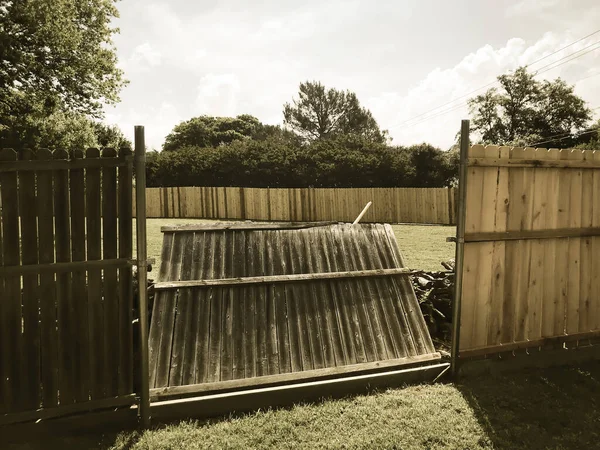 Filtered image collapsed wooden fence near new lumber boards installation of suburbs residential house