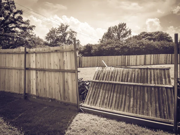 Filtered image collapsed wooden fence near new lumber boards installation of suburbs residential house