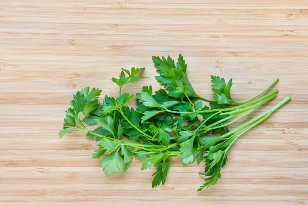 bunch of fresh parsley leaves on chopping board