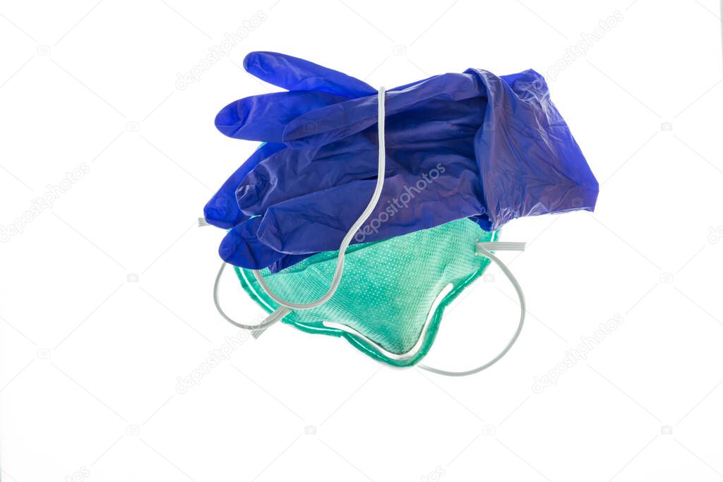 closeup of surgical face mask with blue latex gloves isolated on white background