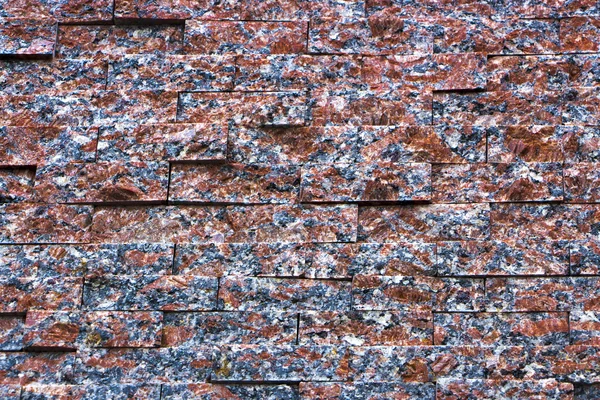 Wall of the small granite blocks — Stock Photo, Image