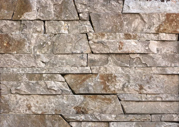 Texture de mur en pierre, carreaux travertin face à la pierre — Photo