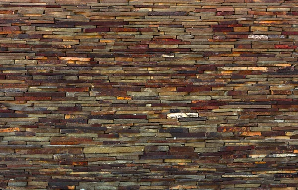 Fragmento de pared artística realizado con múltiples piedras — Foto de Stock
