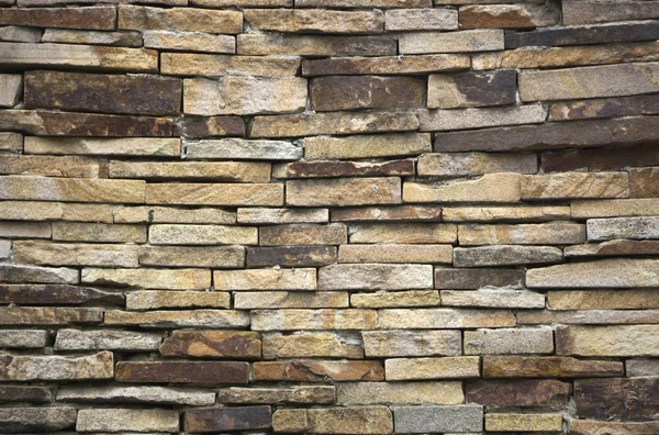 Fragmento de pared artística realizado con múltiples piedras — Foto de Stock