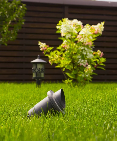 Garden lamp, made in the Middle Ages, on a lawn with a juicy green grass — Stock Photo, Image