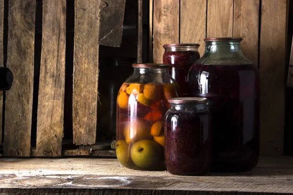 Home preservation in a dark cellar in which breaks through several rays of light — Stock Photo, Image