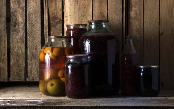 Home preservation in a dark cellar in which breaks through several rays of light — Stock Photo, Image