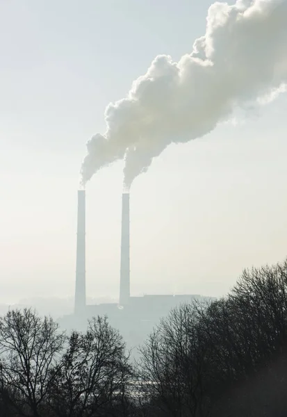Rook uit fabrieksschoorstenen tegen de blauwe hemel. Vervuiling. — Stockfoto