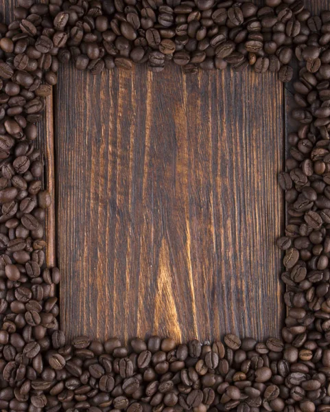 Roasted coffee beans on wood texture — Stock Photo, Image