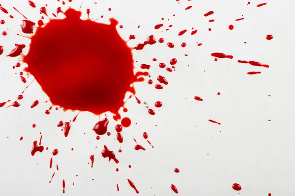 Gotas de sangre roja sobre papel blanco —  Fotos de Stock