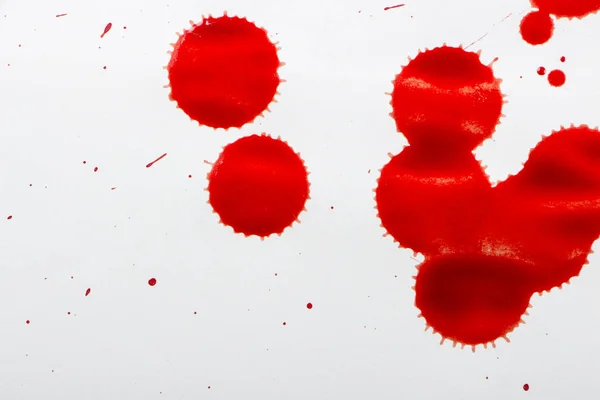 Gotas de sangre roja sobre papel blanco —  Fotos de Stock