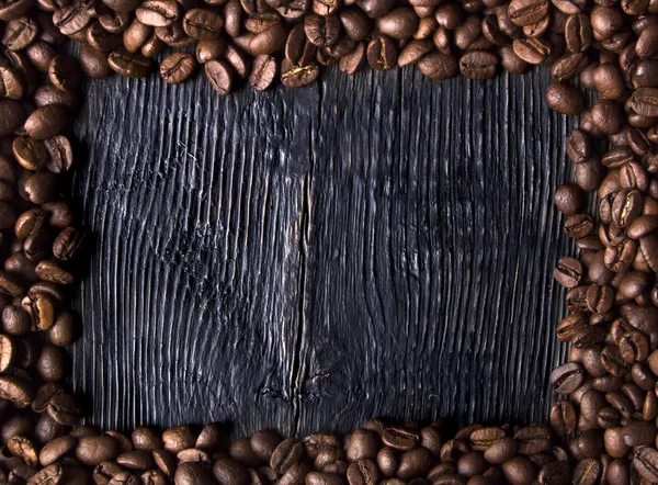 Roasted coffee beans on wood texture — Stock Photo, Image