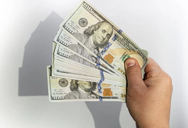 100 dollar banknote in hand shadow falling on white background — Stock Photo, Image