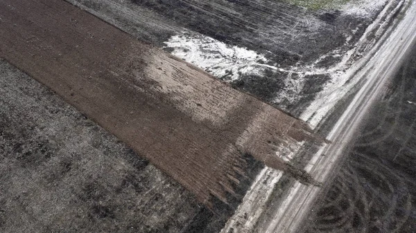 Soil erosion, sand penetrates through the black soil. — Stock Photo, Image