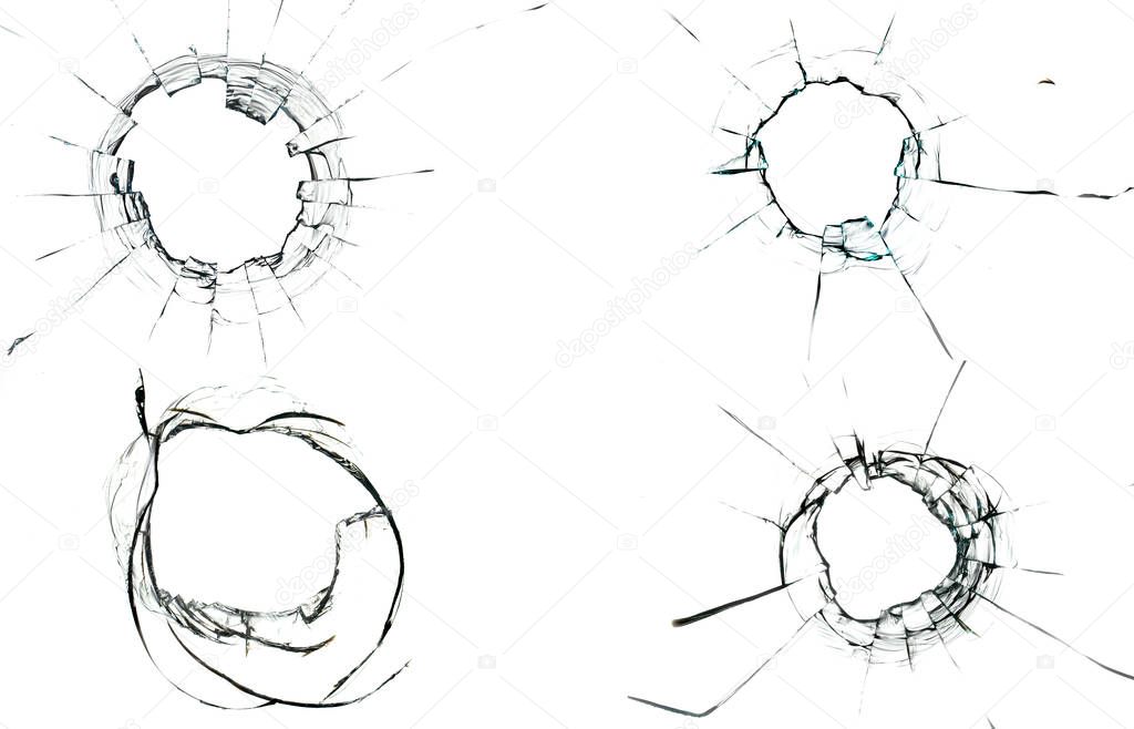 Round white cracks in glass on black background.