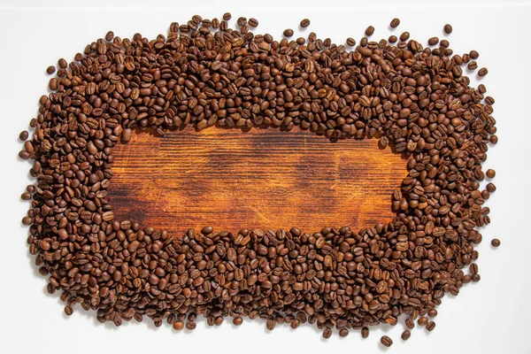 Coffee seeds and wooden texture, natural dark background. — Stock Photo, Image