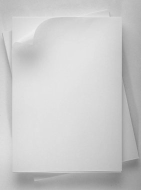Stack of white office paper on light background, top view, place for text.