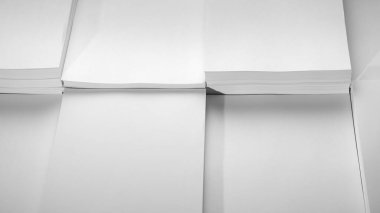 Several stacks of white paper on a white background