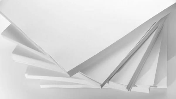 Several stacks of white paper on a white background — 스톡 사진