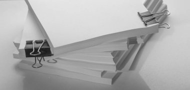 Several stacks of white paper on a white background