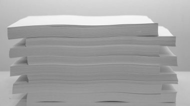 Several stacks of white paper on a white background