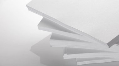 Several stacks of white paper on a white background