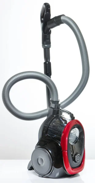 Black and red vacuum cleaner on a white background — ストック写真