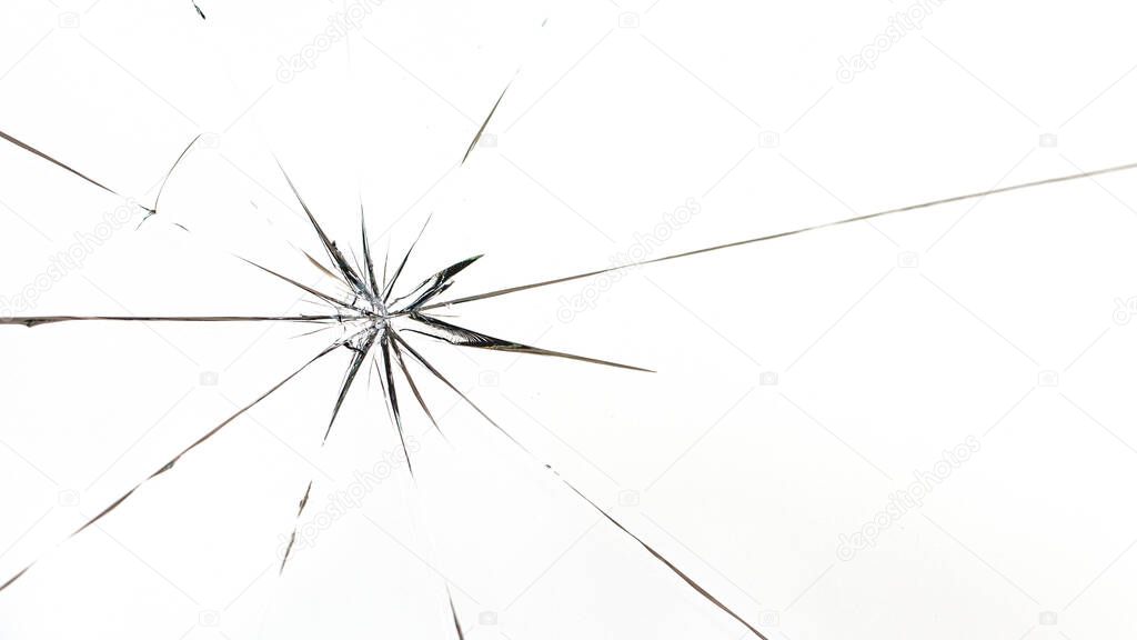 Round cracks in glass on white background. The hole in the glass surface from the bullet.