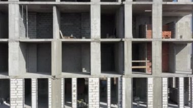 İnsansız hava aracının yavaş uçuşu, çok katlı beton bina inşaatı devam ediyor. Konut inşa kavramı.