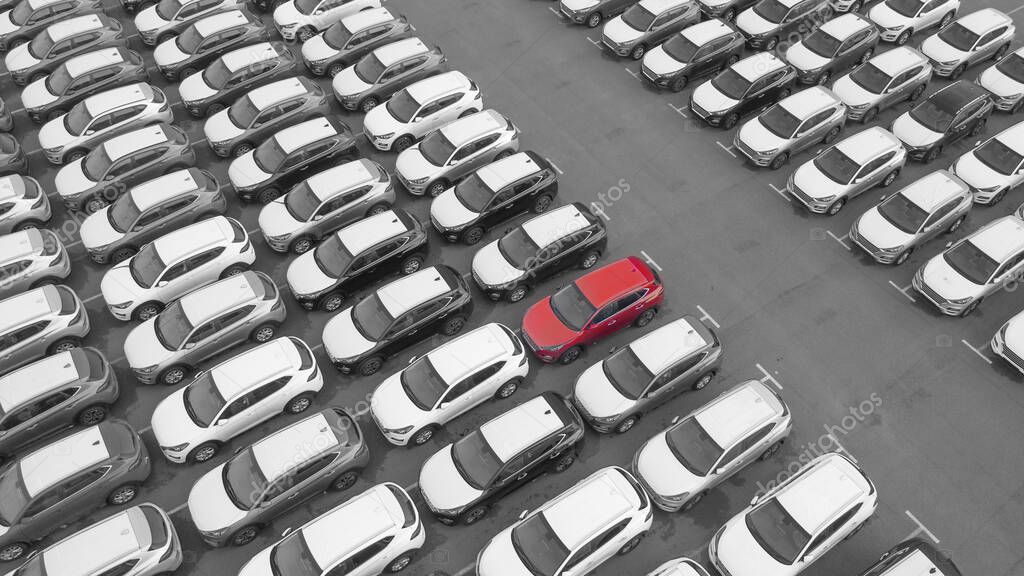 Drone view, new car parking, near the car dealer's logistics center. The parking lot of the updated lineup of cars near the auto shop.