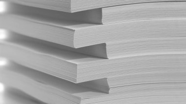 Abstract background, minimalism. Several stacks of white paper for photocopier, on a white background. Office work concept.