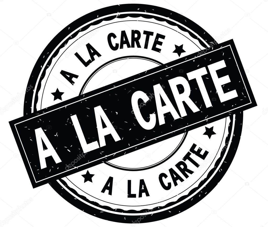 A LA CARTE written text on black round rubber stamp.