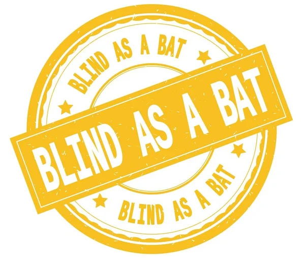 BLIND AS A BAT , written text on yellow round rubber stamp.